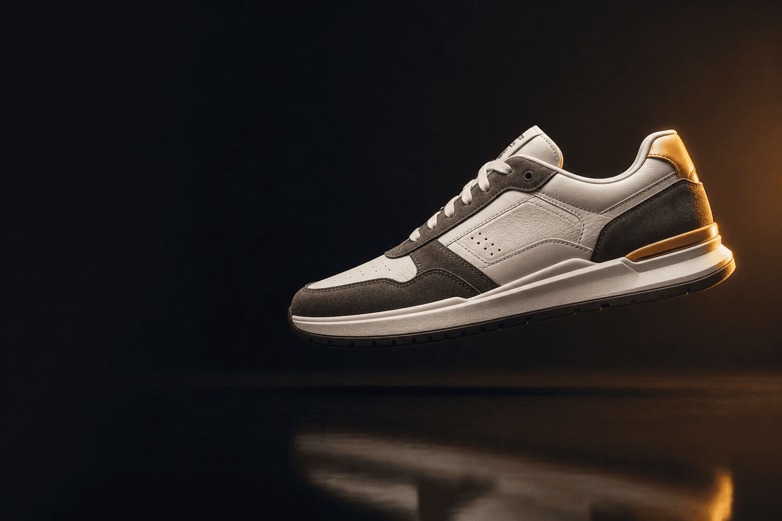 Off-white leather sneaker with charcoal suede panels and an amber heel detail